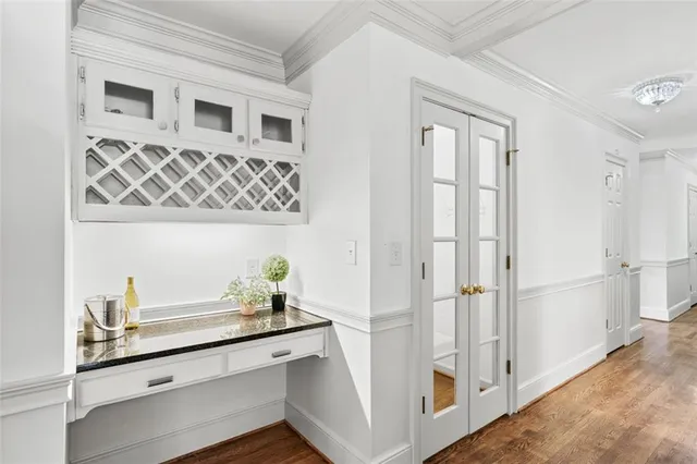 a kitchen with granite countertop white cabinets a sink a window and stainless steel appliances