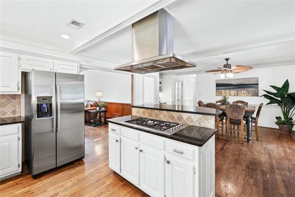 2065 Innsfail Drive Snellville, GA 30078 - Photo 19 of 71 a kitchen with stainless steel appliances a stove a refrigerator and wooden floor