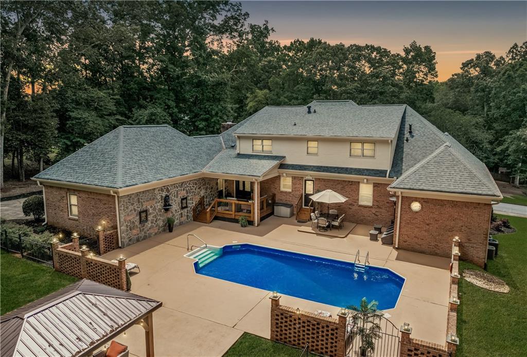 2065 Innsfail Drive Snellville, GA 30078 - Photo 2 of 67 a view of a patio with table and chairs with wooden floor and fence