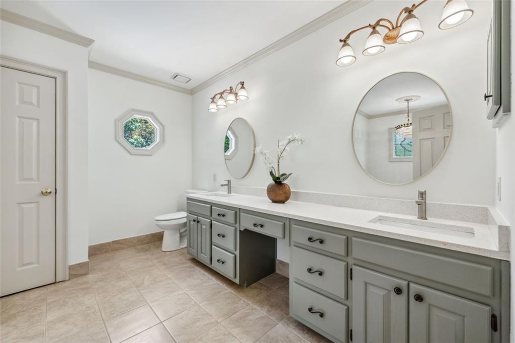 2065 Innsfail Drive Snellville, GA 30078 - Photo 28 of 67 a spacious bathroom with a double vanity sink and a mirror