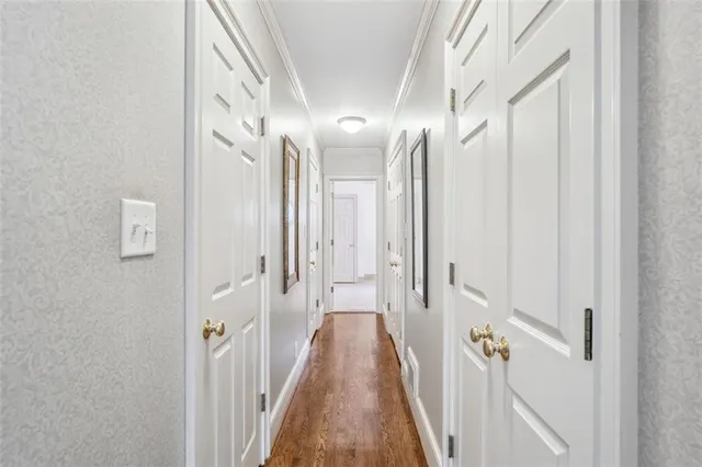 a bedroom with a large bed and a chandelier fan