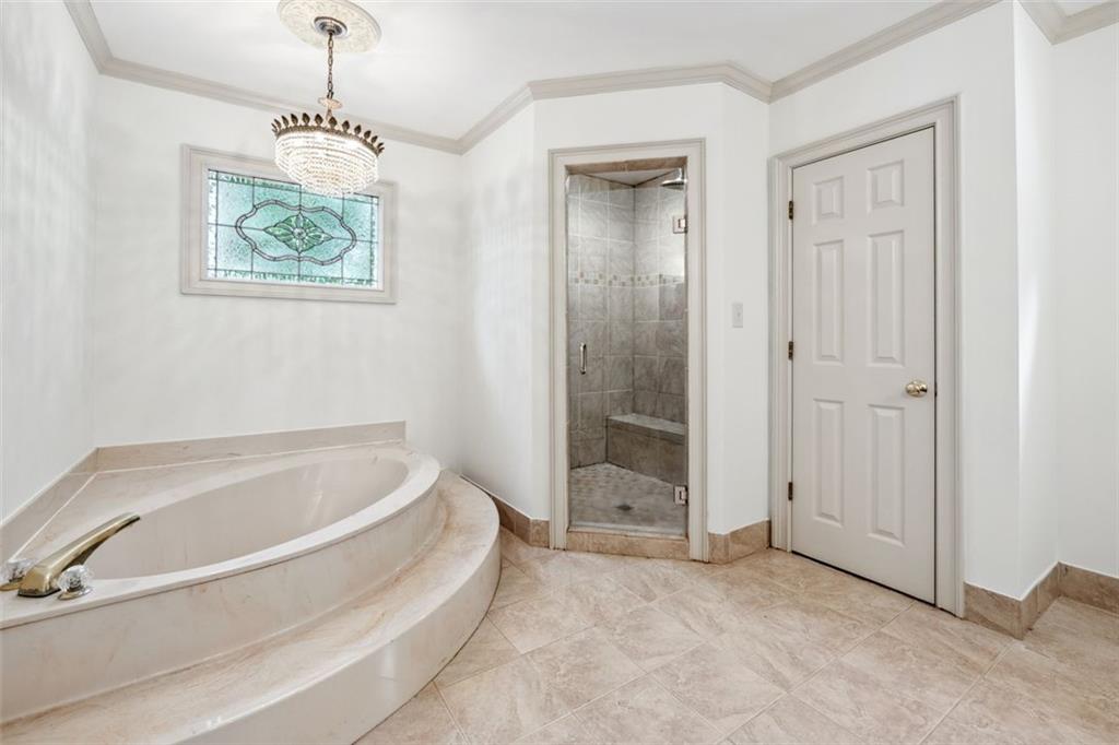 2065 Innsfail Drive Snellville, GA 30078 - Photo 29 of 67 a spacious bathroom with a bathtub and a shower