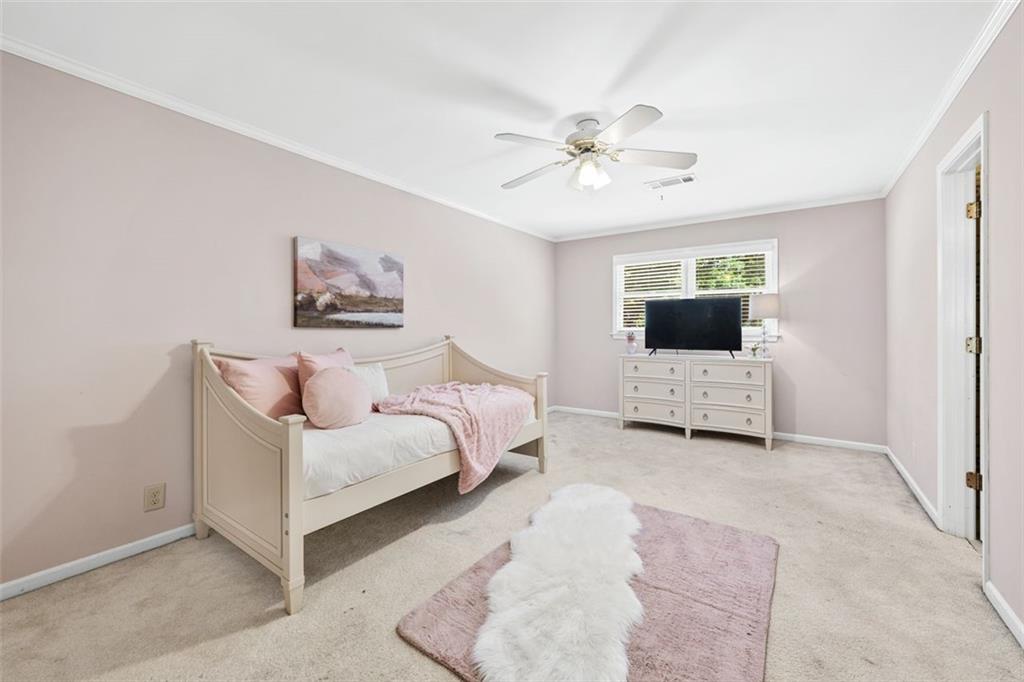 2065 Innsfail Drive Snellville, GA 30078 - Photo 30 of 67 a spacious bedroom with a bed and a flat screen tv