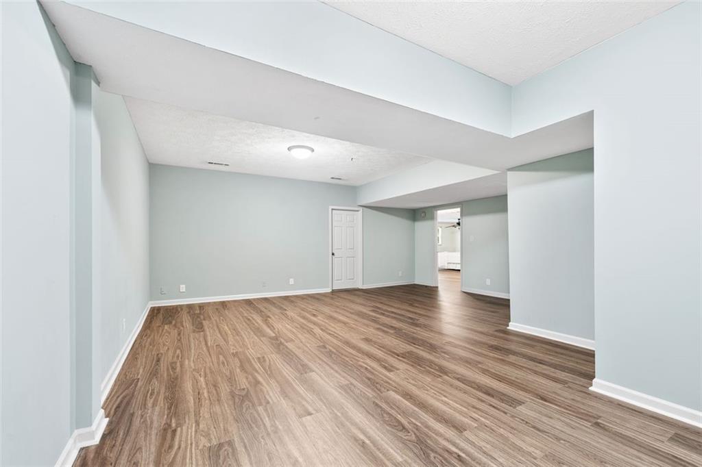 2065 Innsfail Drive Snellville, GA 30078 - Photo 39 of 71 a view of empty room with wooden floor