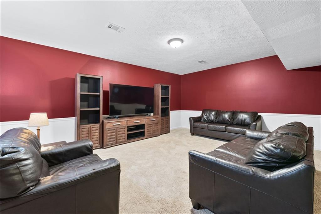 2065 Innsfail Drive Snellville, GA 30078 - Photo 40 of 67 a living room with furniture and a flat screen tv