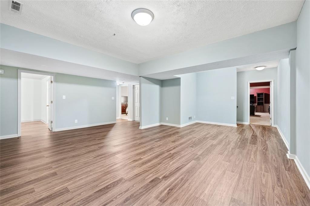2065 Innsfail Drive Snellville, GA 30078 - Photo 40 of 71 a view of empty room with wooden floor