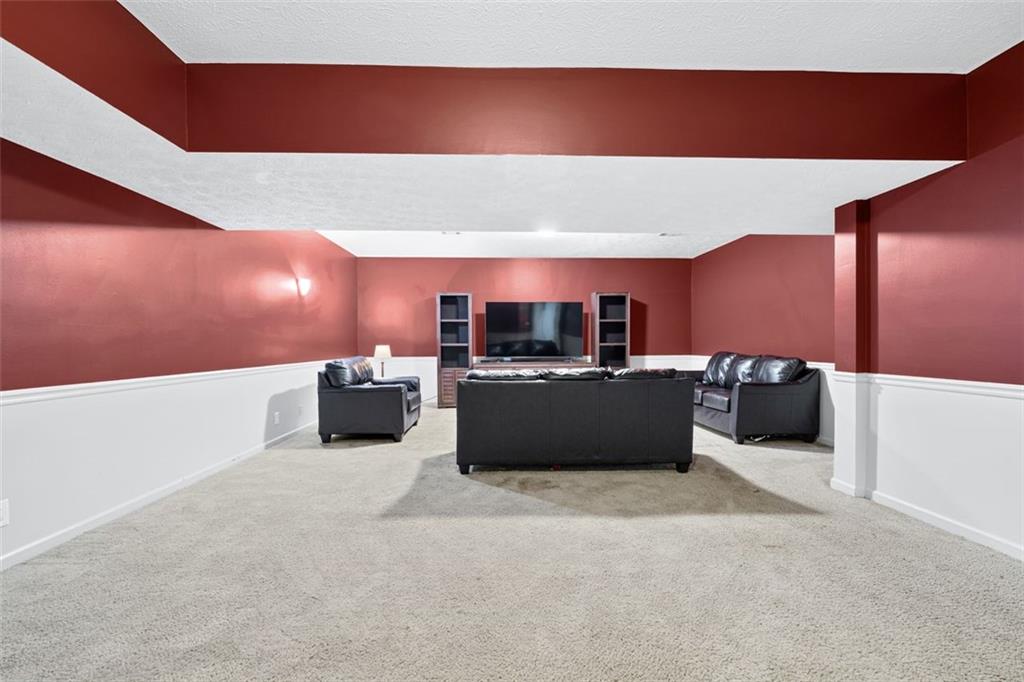 2065 Innsfail Drive Snellville, GA 30078 - Photo 41 of 71 a living room with furniture and a flat screen tv