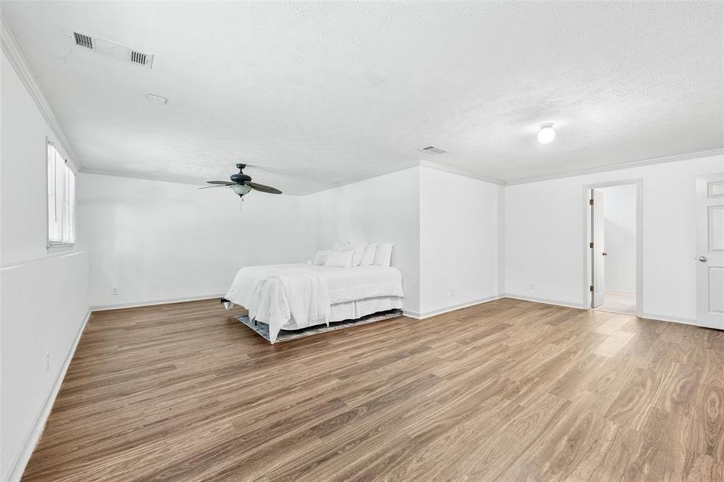 2065 Innsfail Drive Snellville, GA 30078 - Photo 42 of 67 a view of a livingroom with a hardwood floor and a ceiling fan