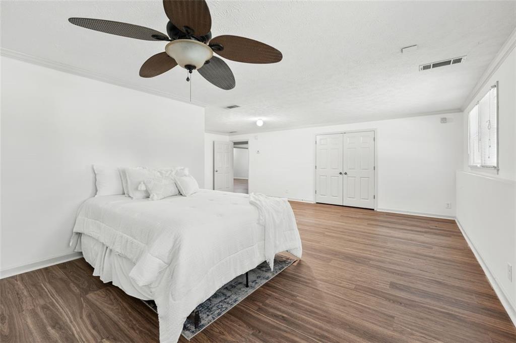2065 Innsfail Drive Snellville, GA 30078 - Photo 43 of 67 a spacious bedroom with a bed and a chandelier