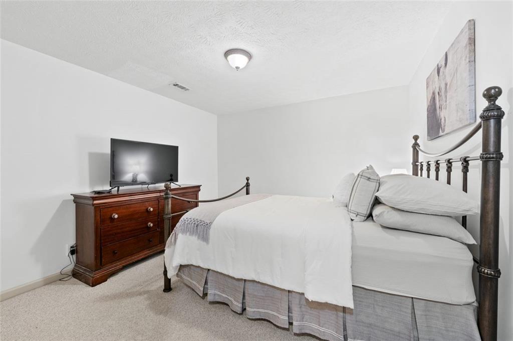 2065 Innsfail Drive Snellville, GA 30078 - Photo 45 of 67 a bedroom with a bed and a flat screen tv
