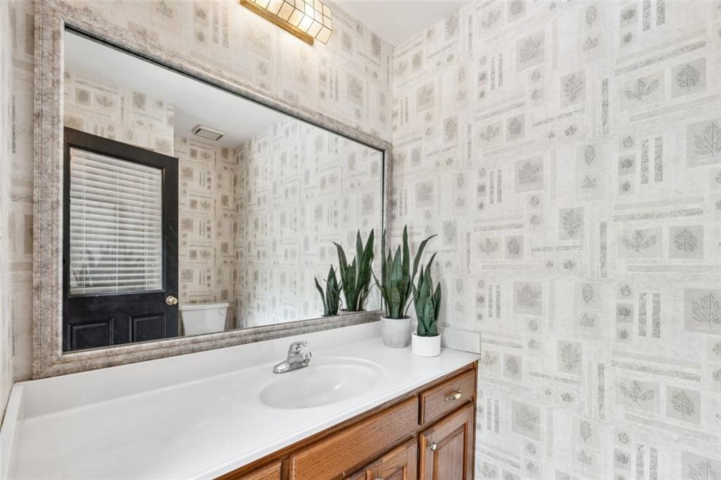 2065 Innsfail Drive Snellville, GA 30078 - Photo 50 of 67 a bathroom with a sink and a mirror
