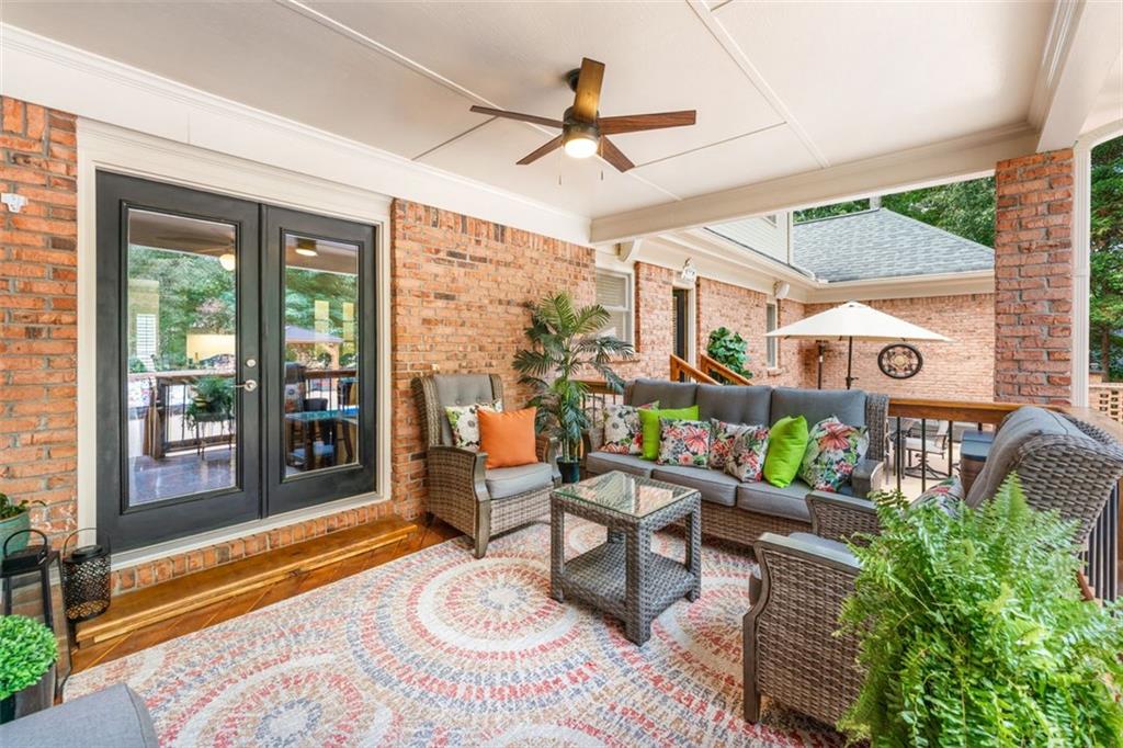 2065 Innsfail Drive Snellville, GA 30078 - Photo 50 of 71 a living room with patio furniture and a floor to ceiling window
