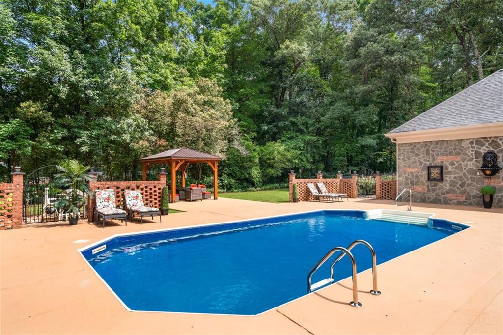 2065 Innsfail Drive Snellville, GA 30078 - Photo 53 of 67 a view of a swimming pool with an outdoor seating
