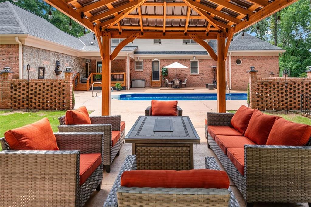 2065 Innsfail Drive Snellville, GA 30078 - Photo 57 of 67 a outdoor space with patio couches and a fireplace