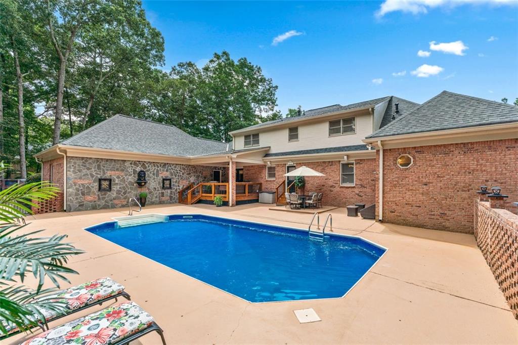 2065 Innsfail Drive Snellville, GA 30078 - Photo 58 of 67 a view of a house with swimming pool and sitting area