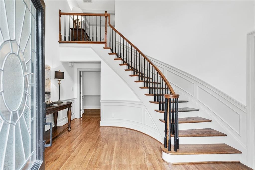2065 Innsfail Drive Snellville, GA 30078 - Photo 6 of 71 a view of staircase with wooden floor and a large window