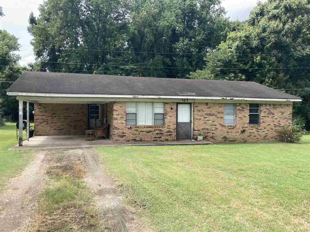 363 Smithville Road Ripley, TN 38063 - Photo 1 of 1 a front view of a house with a garden