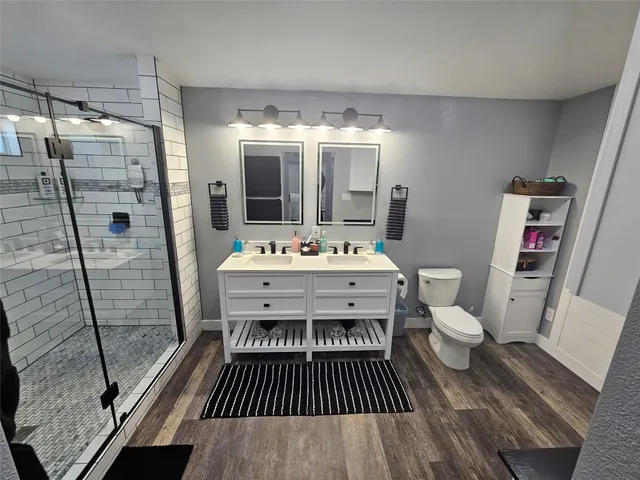 a bathroom with a sink toilet and shower