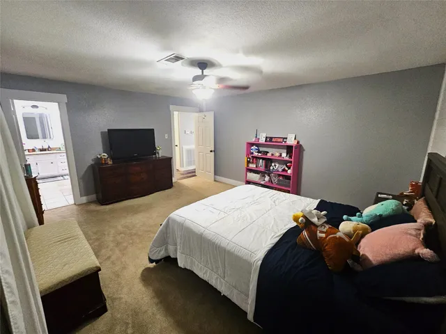 a bedroom with a bed and a television