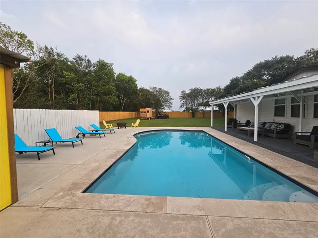a view of a swimming pool with a lounge chair
