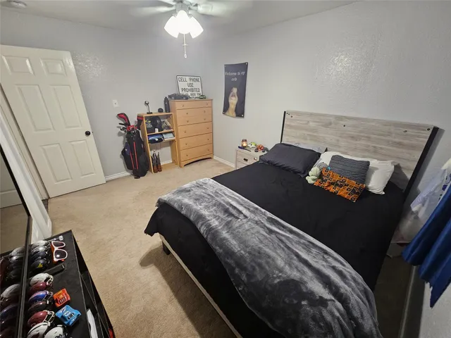 a bedroom with a bed and a mirror