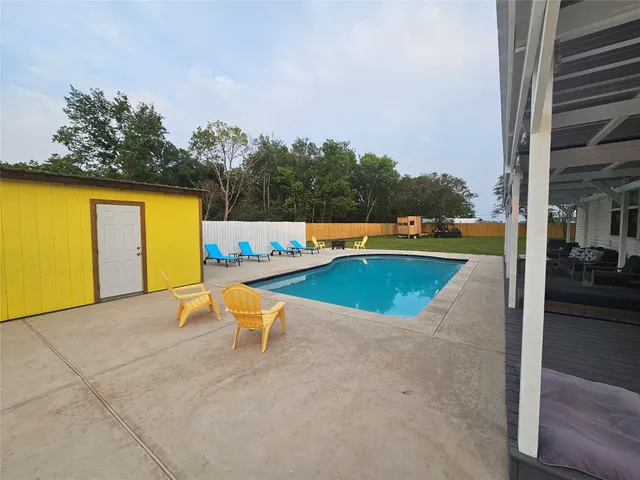 a view of a swimming pool with lounge chair