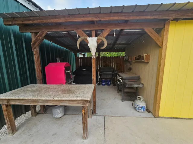 a view of a patio with table and chairs