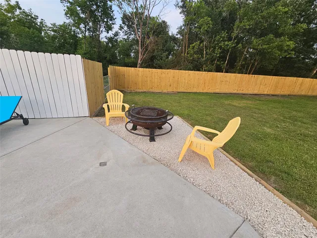 a backyard of a house with table and chairs