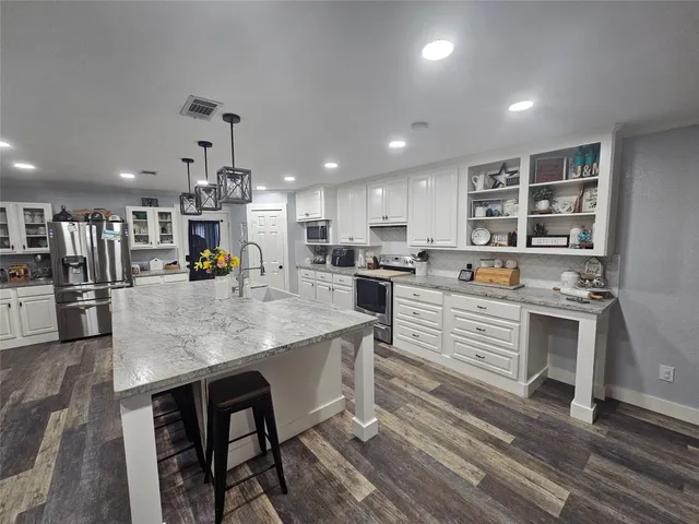 a kitchen with counter top space cabinets and stainless steel appliances