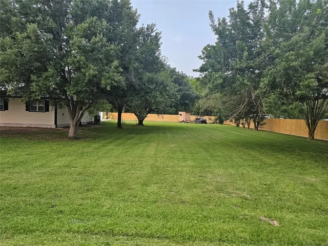a view of pool with a yard