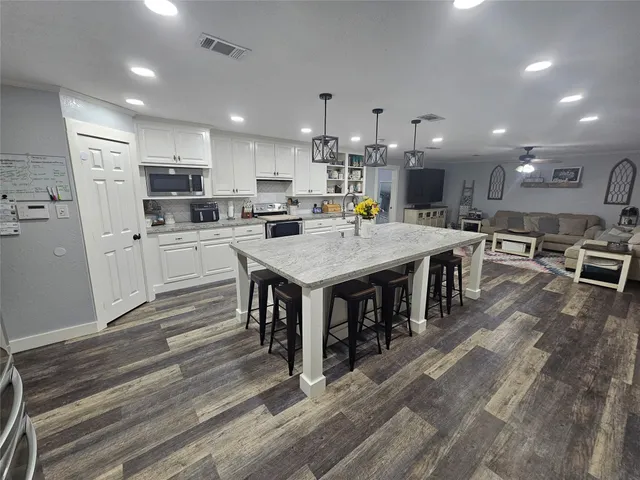 a large kitchen with a table and chairs in it