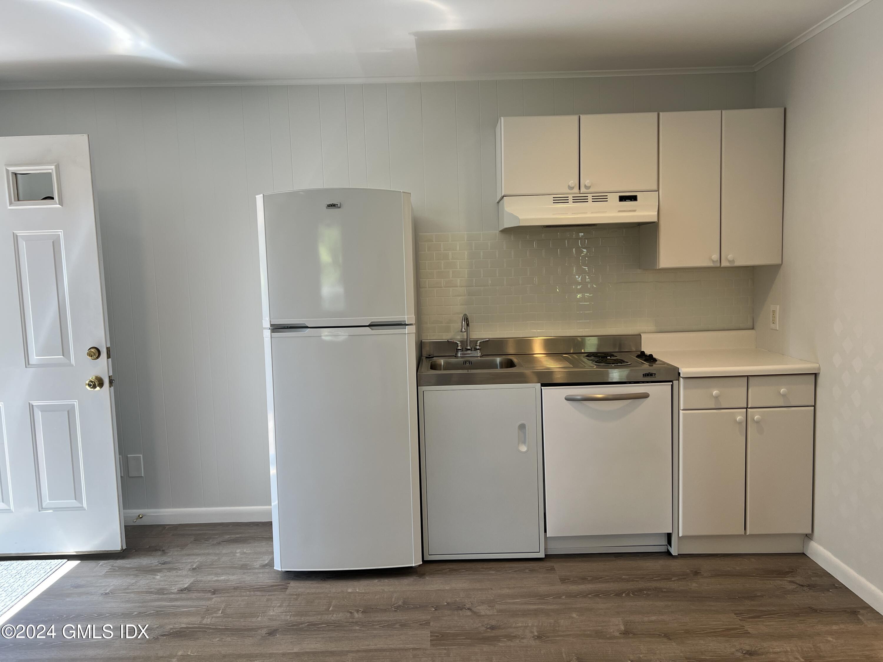 3 Silver Beech Road Riverside, CT 06878 - Photo 4 of 10 a kitchen with white cabinets and white appliances