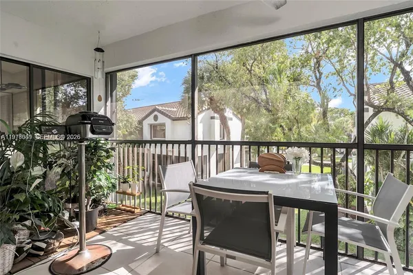 a view of a city from a balcony with furniture