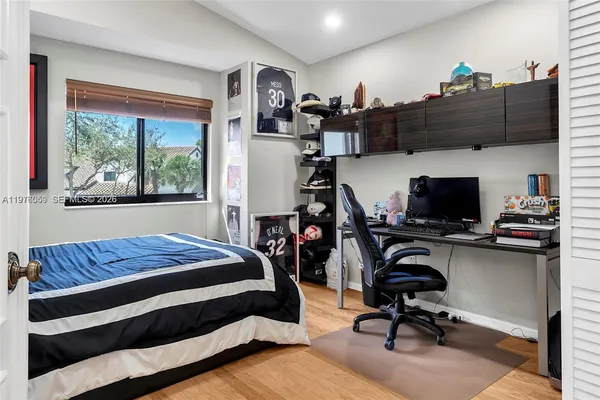 a bedroom with a workspace