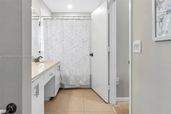 a bathroom with a double vanity sink a mirror and a shower