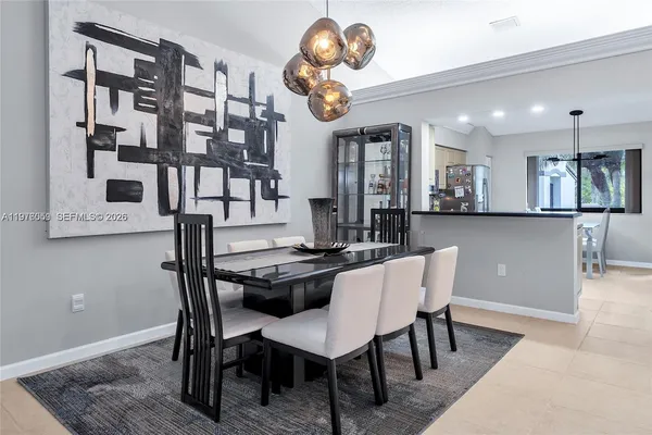 a view of a dining room with furniture and chandelier