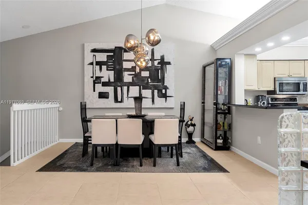 a dining room with furniture and wooden floor