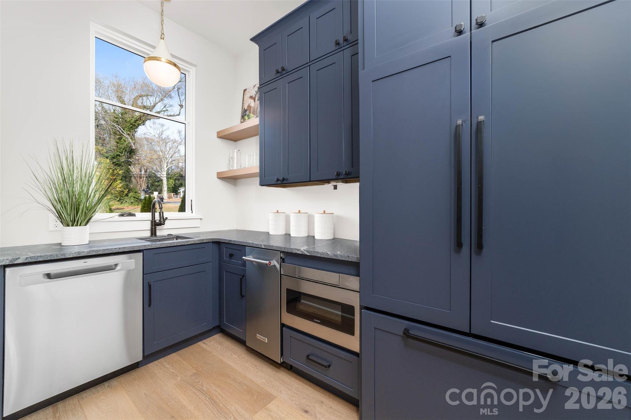 216 Walnut Street Davidson, NC 28036 - Photo 13 of 48 a kitchen with a sink and a refrigerator