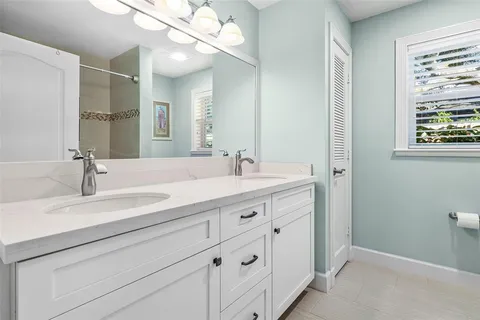 a large bed sitting in a bedroom next to a window