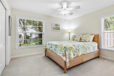 a bedroom with a bed and a large window with outer view