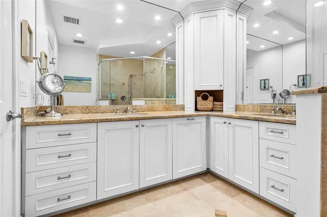 a bathroom with a granite countertop sink mirror and shower