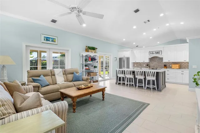 a kitchen with kitchen island granite countertop stainless steel appliances a refrigerator and a dining table