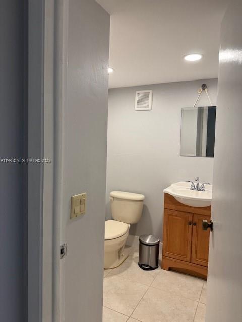 16300 Golf Club Road, Unit 208 Weston, FL 33326 - Photo 18 of 24 a bathroom with a toilet sink and mirror