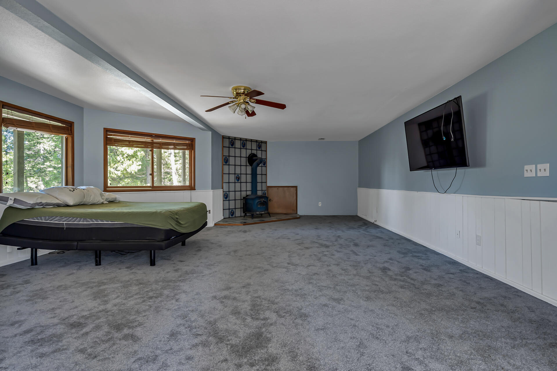 15368 Star Flower Road Oak Run, CA 96069 - Photo 57 of 63 a spacious bedroom with a bed and a flat screen tv