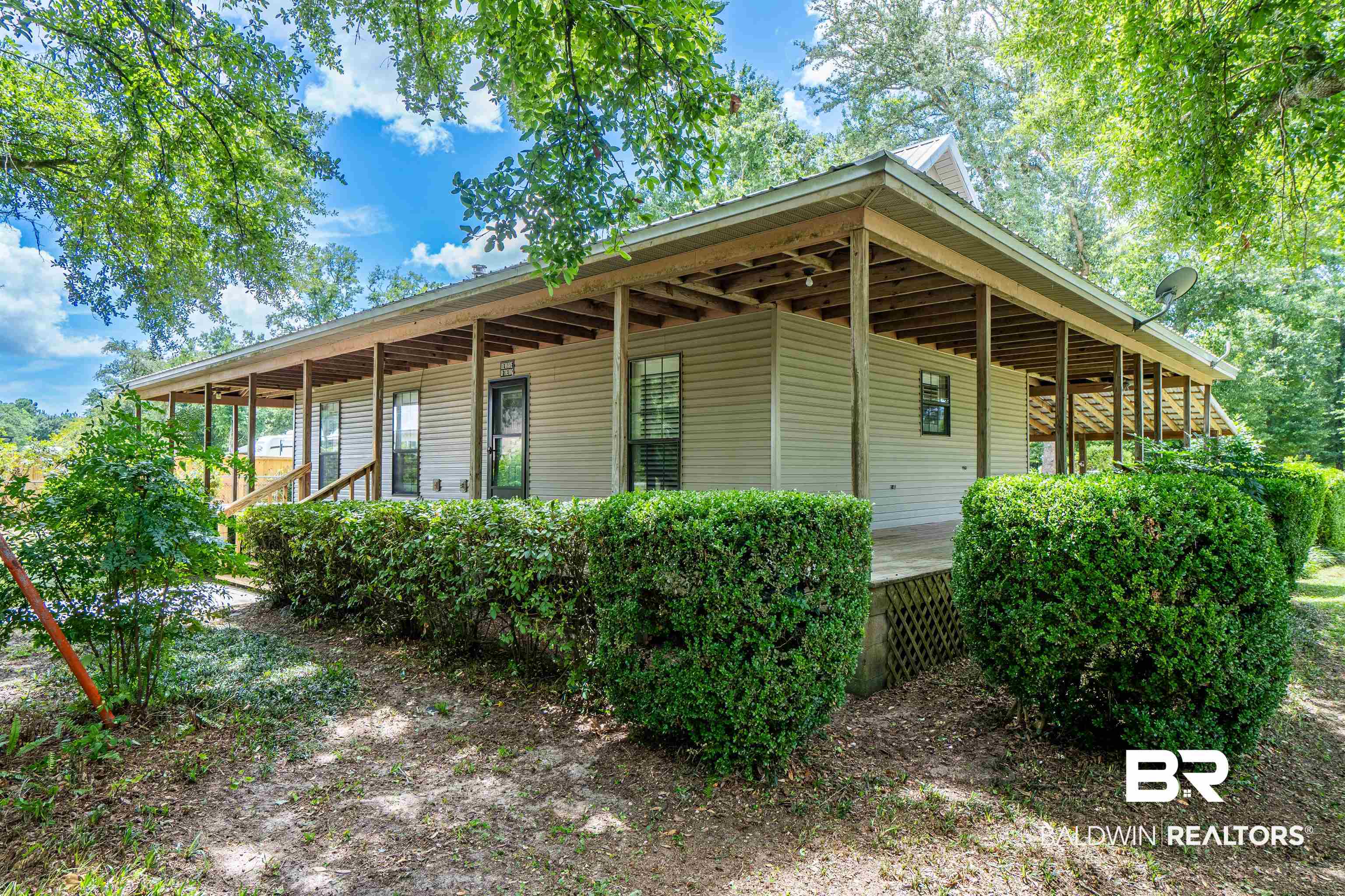 View of property exterior featuring covered porch