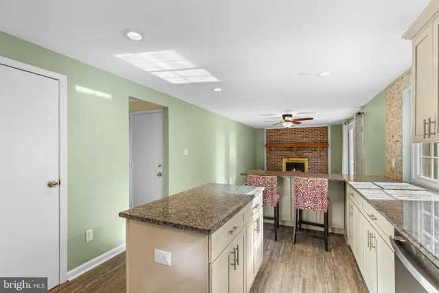 a kitchen with kitchen island a sink stove and refrigerator