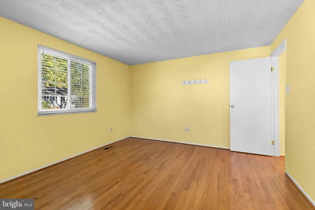 a bathroom with a granite countertop sink a mirror a bathtub and shower