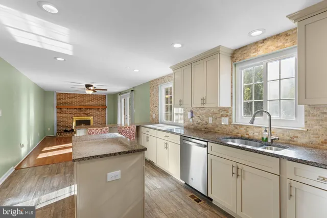 a kitchen with stainless steel appliances granite countertop a sink stove and cabinets