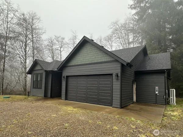 a front view of a house with yard and garage