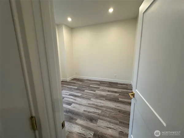 a view of a room with wooden floor and window